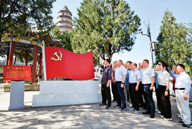在学习贯彻习近平新时代中国特色社会主义思想主题教育中，全党紧扣“学思想、强党性、重实践、建新功”总要求，聚焦主题主线，明确目标任务，突出以学铸魂、以学增智、以学正风、以学促干，与做好开局之年工作紧密结合，特别是着力解决制约高质量发展问题、群众急难愁盼问题、党的建设突出问题，达到预期目的，取得明显成效。图为2023年6月30日，在延安宝塔山参观的党员干部重温入党誓词。 新华社记者 张博文/摄