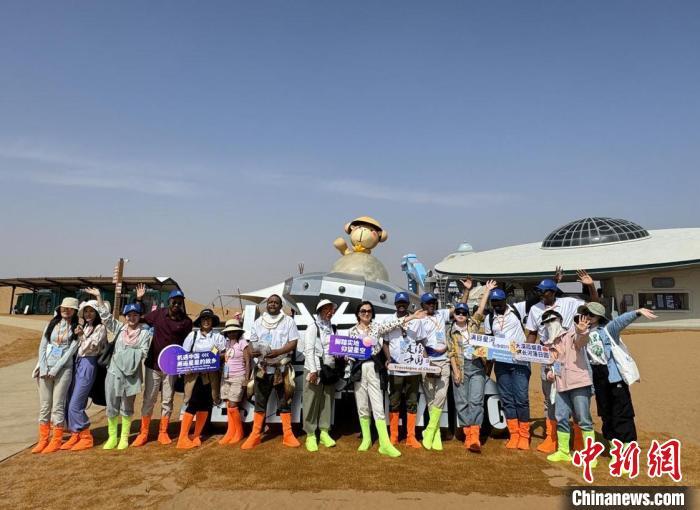 9月22日，外媒记者与工作人员在宁夏沙坡头国家级自然保护区内合影留念。张硕 摄