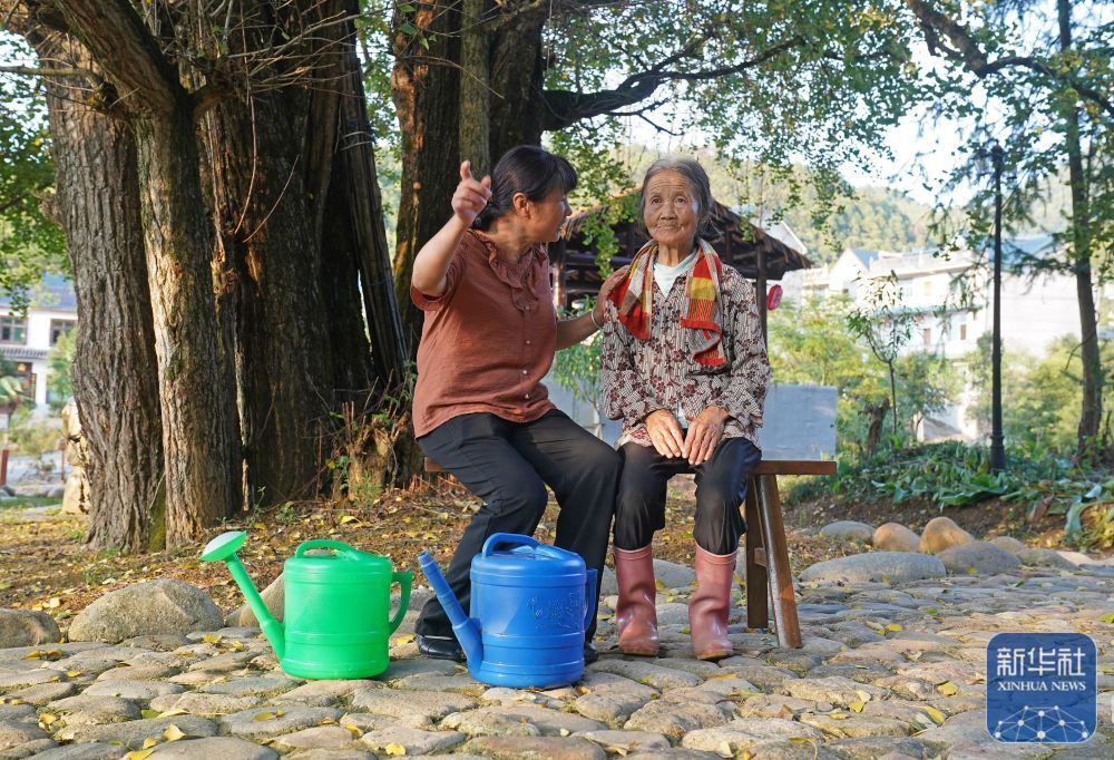 江西省铅山县陈坊乡沽溪村，罗细英（左）与一位相识的老人聊天（9月28日摄）。