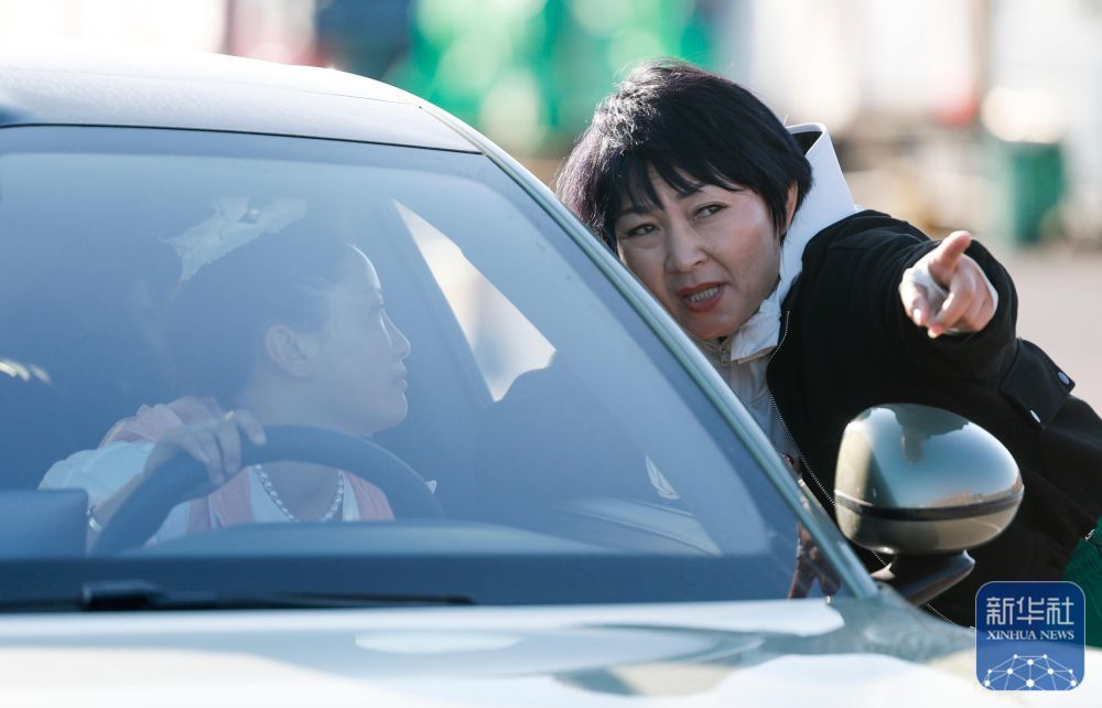 在新疆霍尔果斯公路口岸,高云(右)在等待出关时与另一名“摆渡人”交流(5月29日摄)。