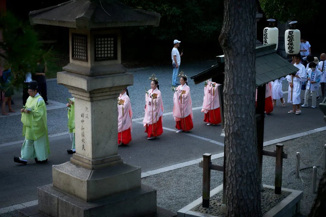 A group of people walking down a street