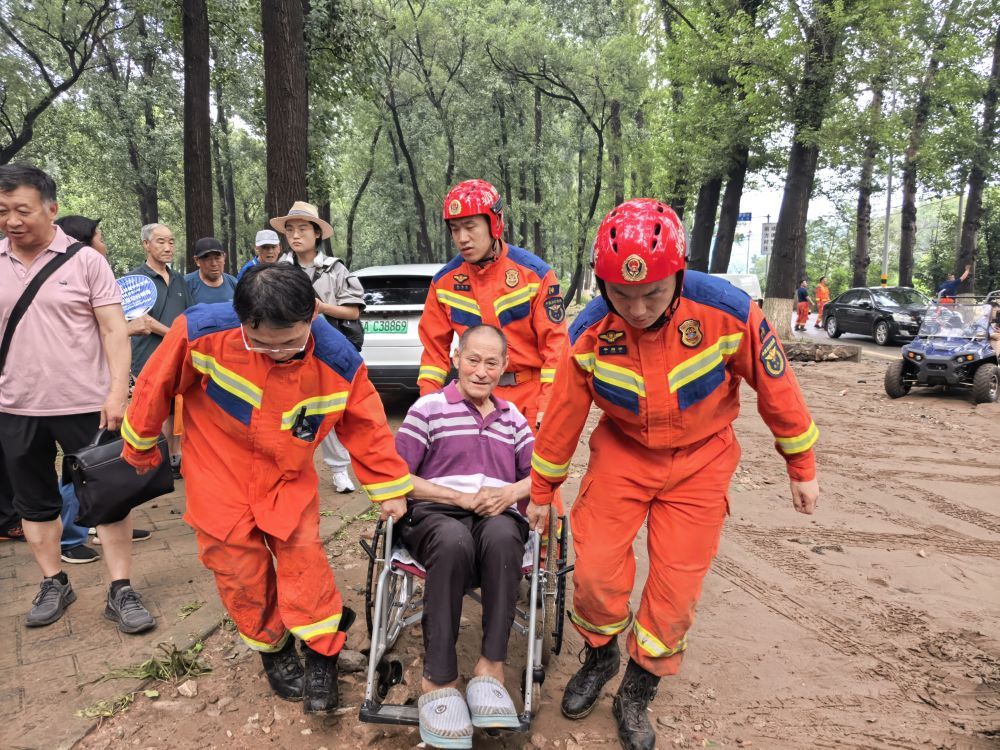 7月28日，救援人员在北京市平谷区镇罗营镇转移群众。新华社记者 余佩璇 摄