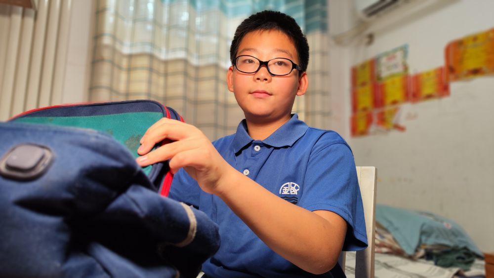 河南省开封市金明小学学生潘岳林在整理书包,迎接新学期的到来。(王正一摄)