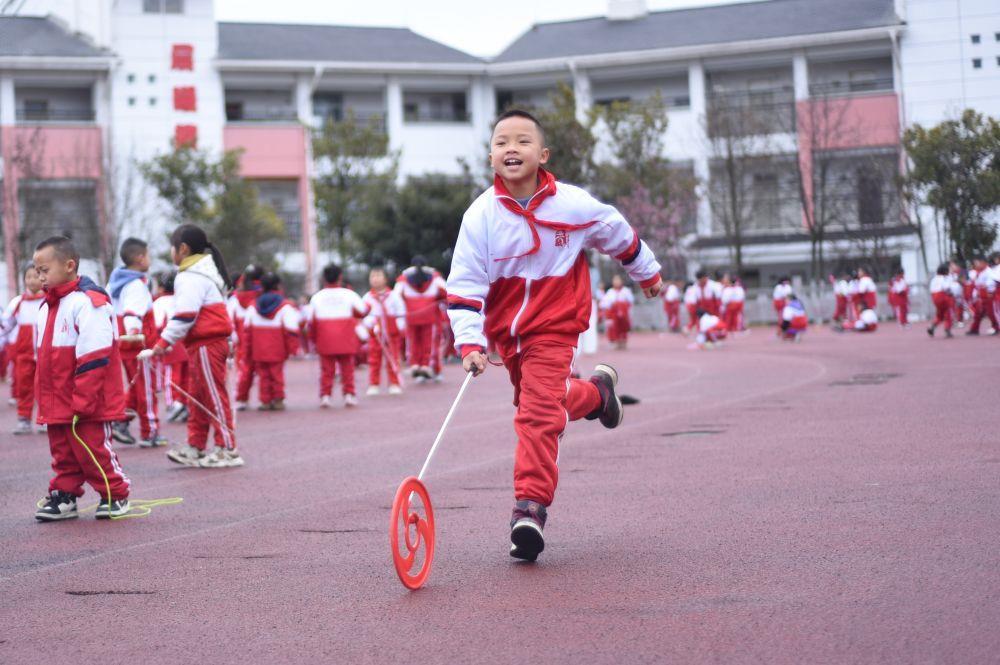 △2025年2月25日，贵州贵阳，一名学生在大课间滚铁环。