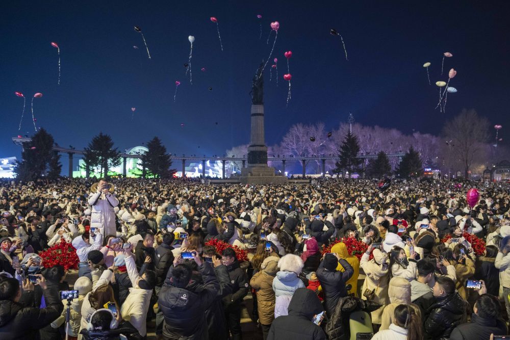 2025年1月1日凌晨，在哈尔滨市防洪纪念塔附近，人们放飞气球迎接新年。新华社记者 谢剑飞 摄