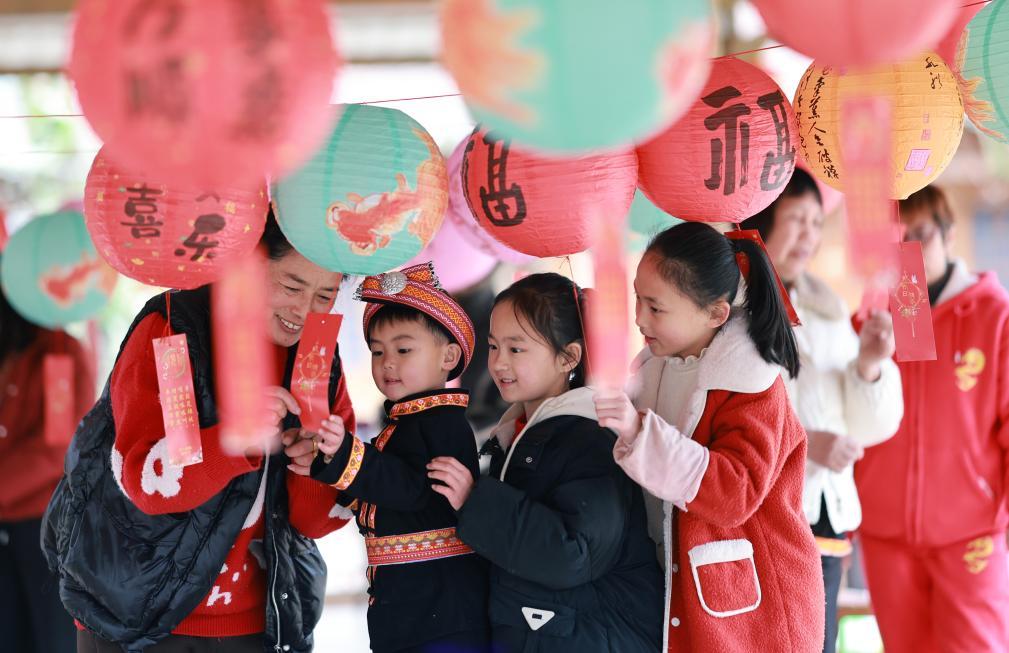 2月10日,人们在广西桂林市灵川县兰田瑶族乡西江寨参与猜灯谜活动。新华社发(刘教清 摄)