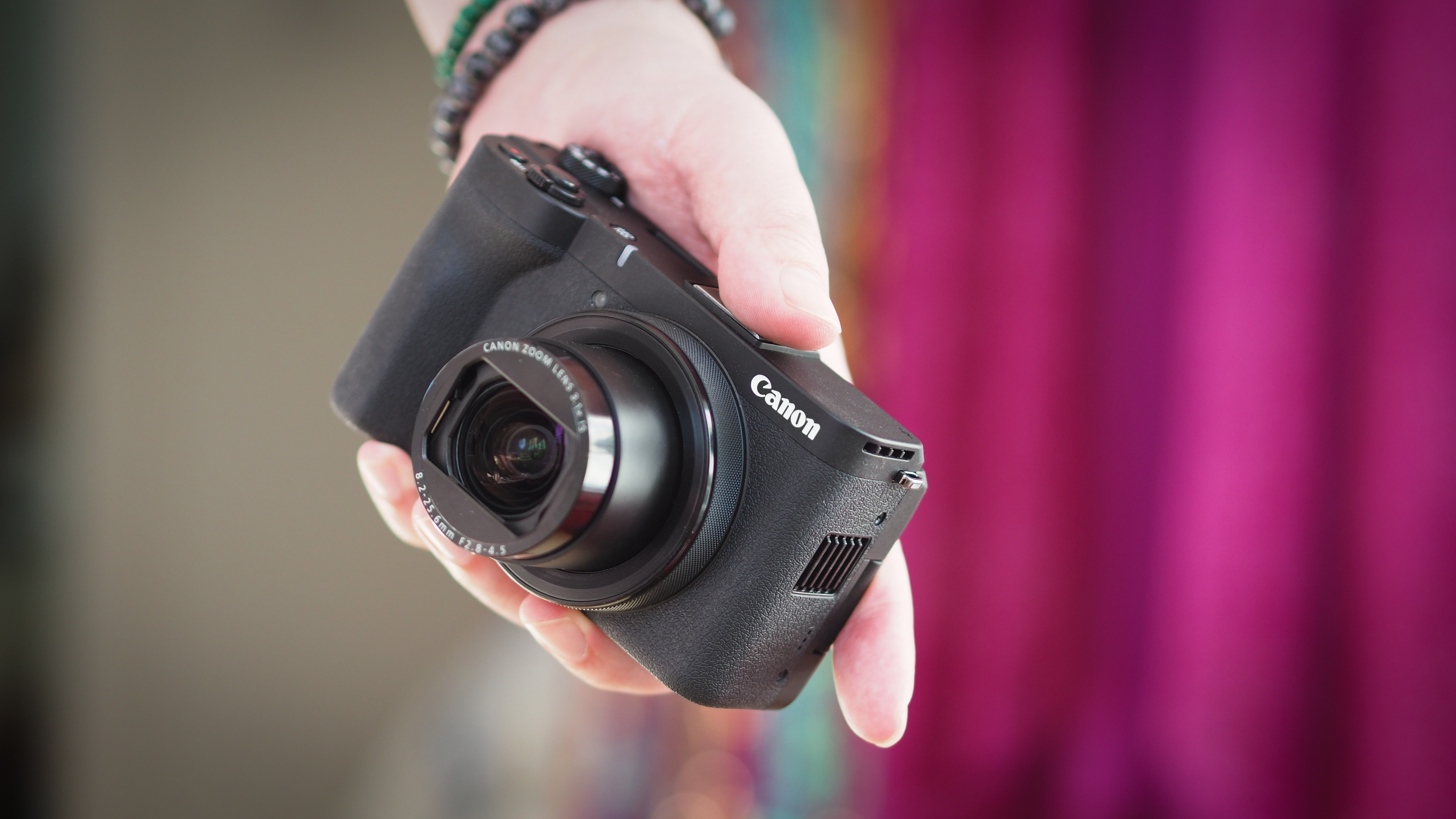 Canon PowerShot V1 in the palm of a photographer's hand