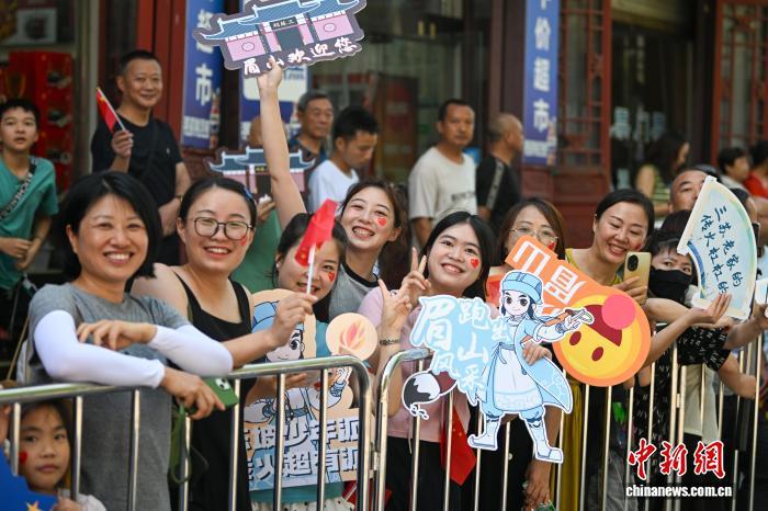 7月26日，成都世运会火炬传递活动在四川成都、德阳、眉山3个城市进行。图为眉山三苏祠站传递现场，民众为火炬手们助威呐喊。　中新社记者 刘忠俊 摄
