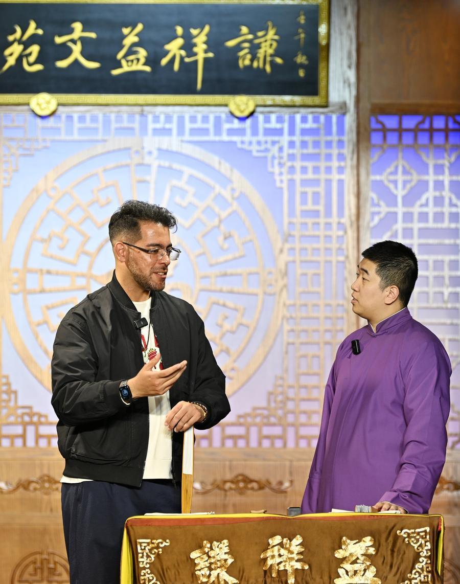 4月24日，在天津市红桥区谦祥益相声茶馆，吴瑞龙（左）和相声演员在台上交流。
