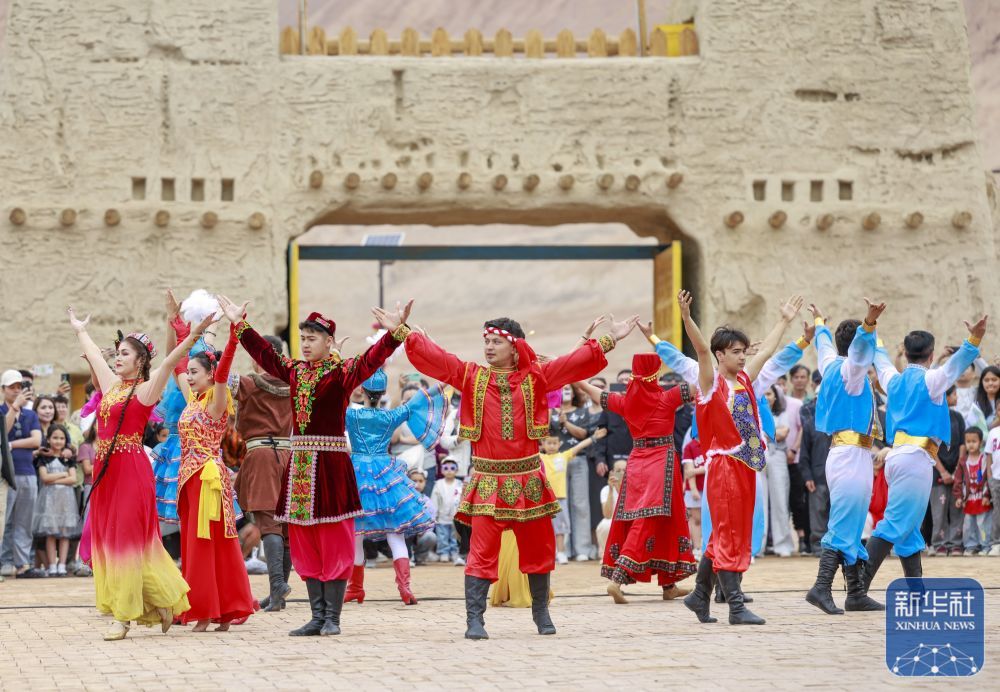 ↑ 5月4日,演员在新疆吐鲁番市鄯善县吐峪沟景区表演民族歌舞。