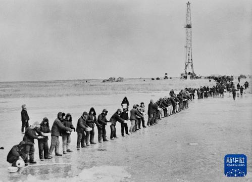 20世纪60年代初期，大庆油田工人在艰苦创业之初破冰取水。新华社发