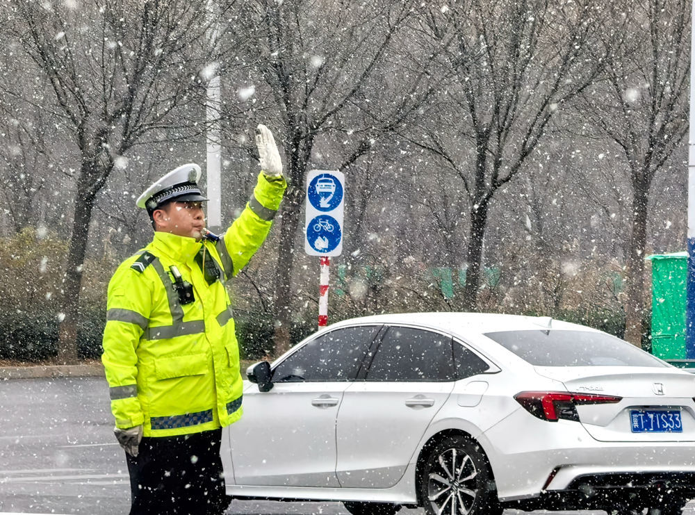 12&#2637612日，在河北省衡水市，交警在雪中指挥交通。新华社发（陈连胜摄）