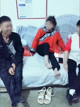 杨琴身穿布依族传统服饰坐在哥哥姐姐中间