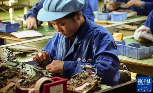 2000年2月，广东东莞长安镇一家电子有限公司生产线上的女工。新华社发