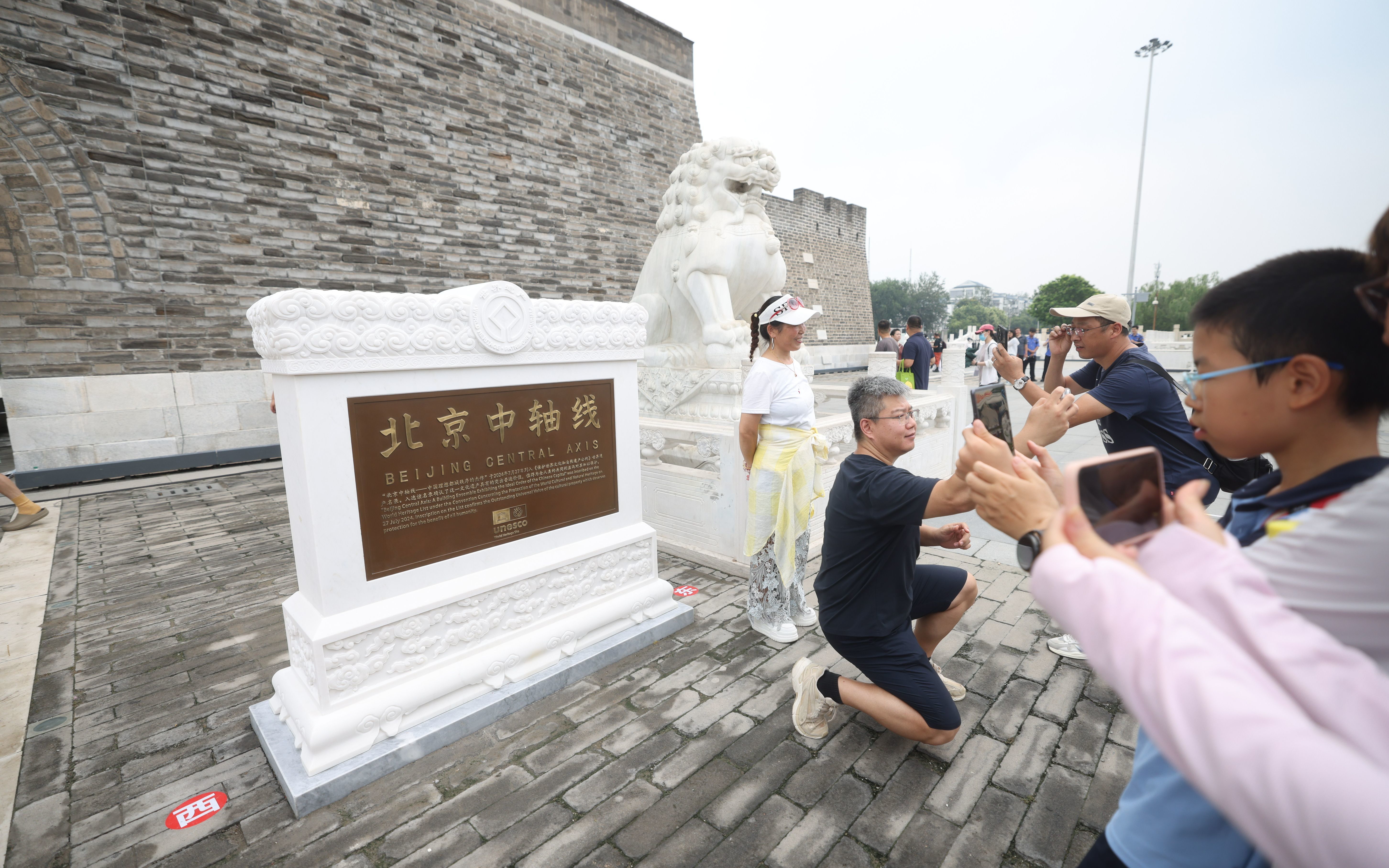 2025年7月27日,“北京中轴线世界文化遗产标志碑”前,市民拍照留念。新京报记者 王贵彬 摄