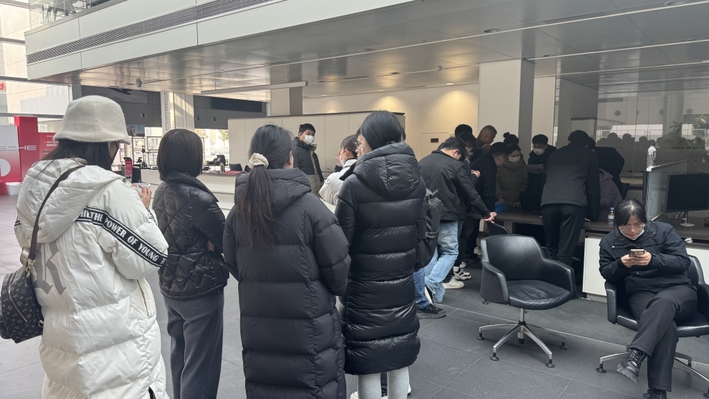 郑州中原保时捷中心内,员工和消费者正在进行登记。