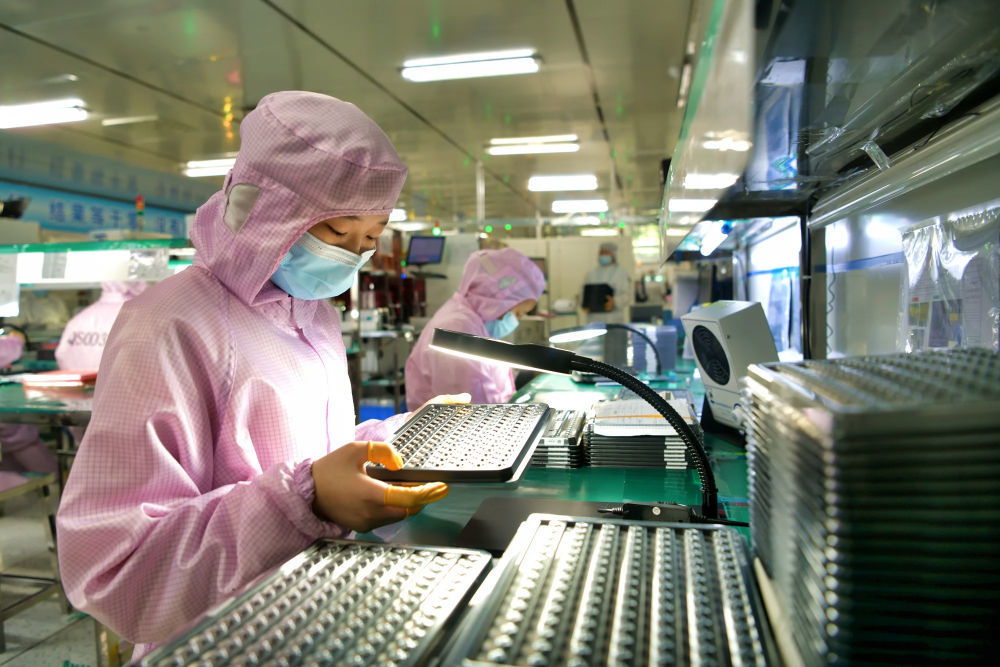 5月27日，在位于湖北省咸宁市通城县的湖北三赢兴光电科技股份有限公司无尘车间内，工人在生产准备出口的智能摄像头模组。新华社发（刘建平 摄）