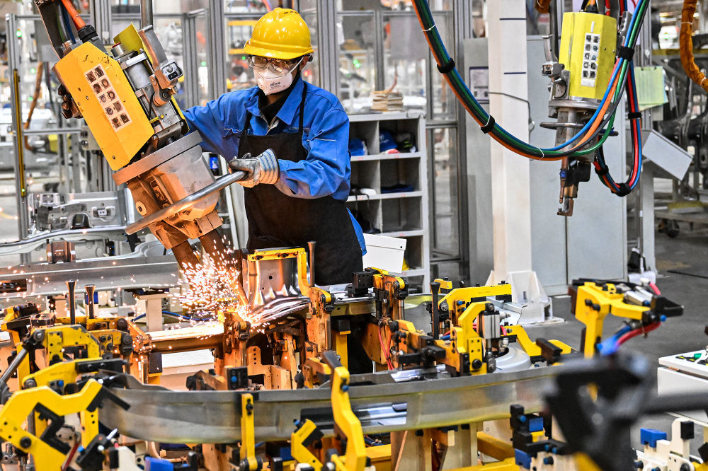 　　12月12日，在河南省商丘市豫商经济技术开发区一家新能源汽车企业，工人在新能源轻卡车生产线上赶制产品订单。新华社发（李恒摄）