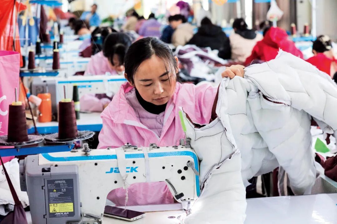 11月19日,河南信阳市一家羽绒服饰公司的生产车间。图/视觉中国