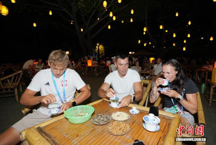 8月6日晚,成都世运会外籍运动员等在成都望江楼公园品成都盖碗茶。 中新社记者 安源 摄