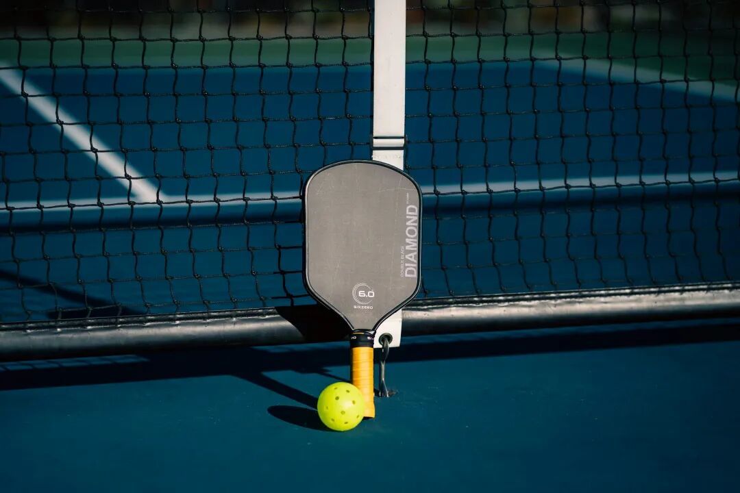 A tennis racket and ball on a tennis court