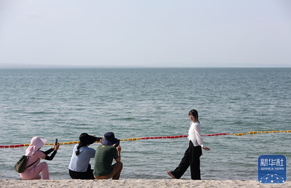 ↑ 9月8日，游客在新疆阿勒泰地区福海县乌伦古湖金沙滩景区拍照。