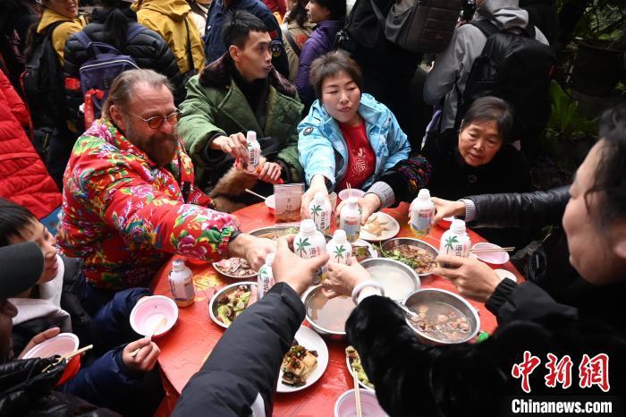 资料图为斯蒂芬(穿花棉袄男子)在重庆江津中山古镇与民众聚餐。张旭 摄