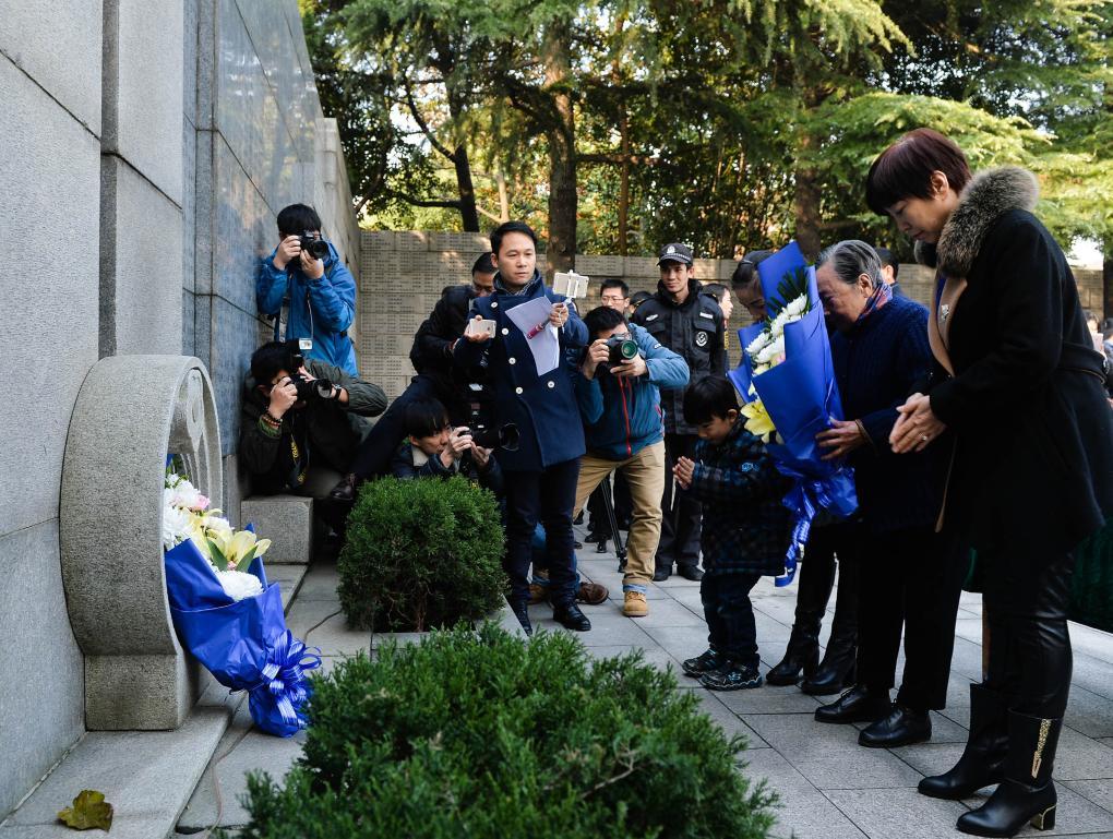 ↑2016年12月3日，夏淑琴（右二）和家人在侵华日军南京大屠杀遇难同胞纪念馆向遇难者献花。