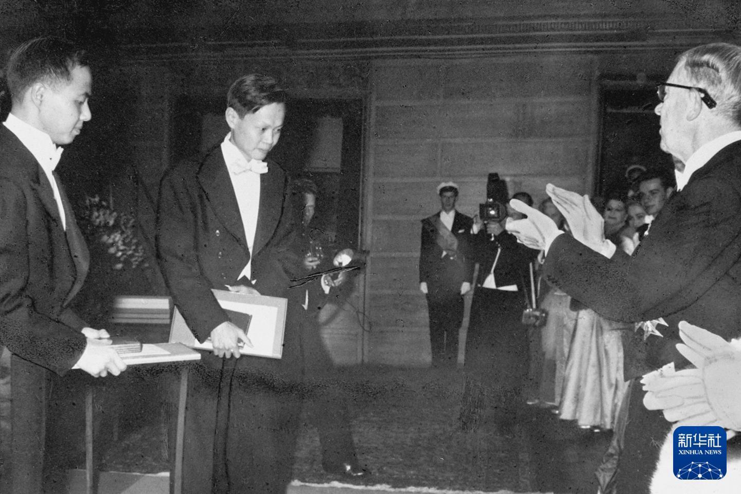 1957年,杨振宁(中)和李政道(左)在瑞典斯德哥尔摩获颁1957年诺贝尔物理学奖。新华社发