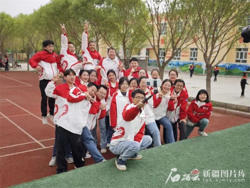 今年春季新学期开学时，谢依特小学戍边支教西部计划志愿者服务队队员们在校园内合影留念。谢依特小学供图