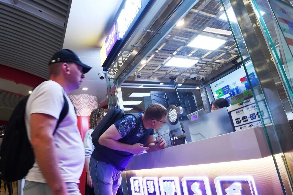 外籍游客在地铁王府井站咨询兑换外币业务