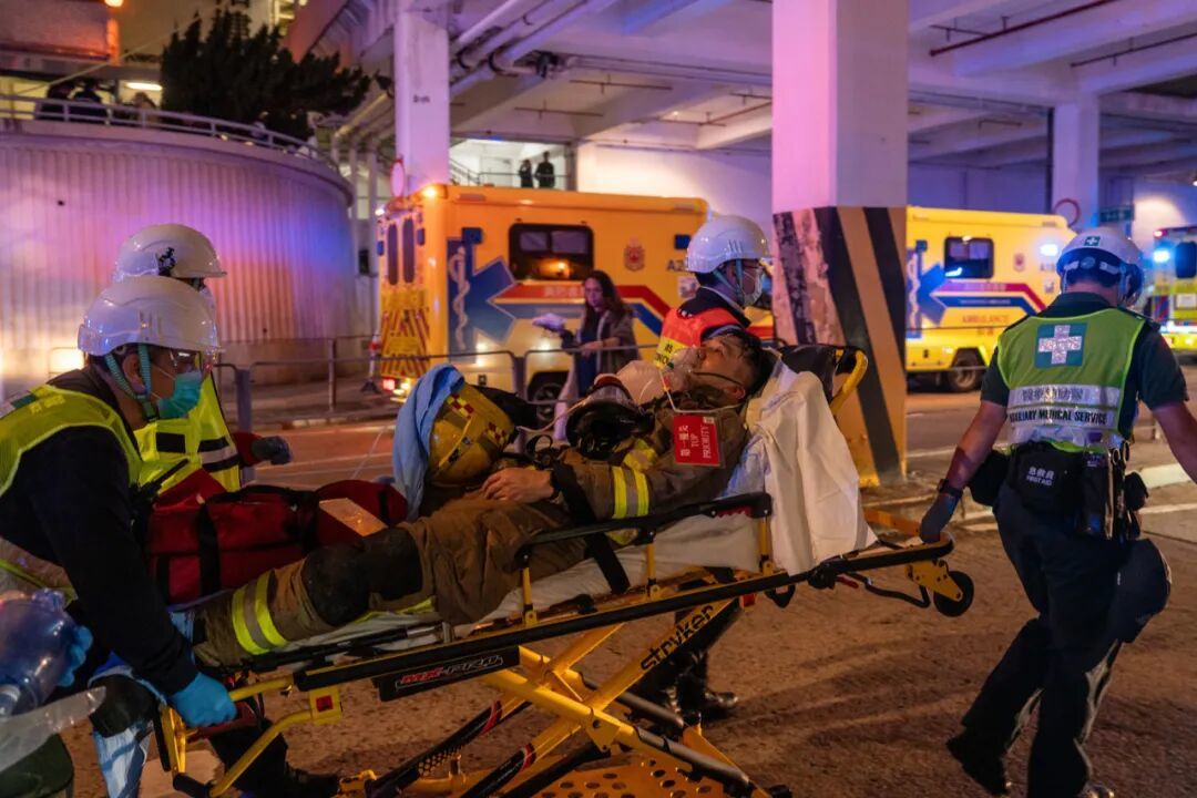 11月26日,香港新界大埔區宏福苑發生五級火警。圖為救援人員緊急將消防人員送醫。