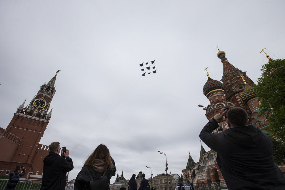 2020年5月9日,在俄罗斯莫斯科红场,人们观看并拍摄纪念卫国战争胜利75周年的空中阅兵。新华社发(亚历山大摄)