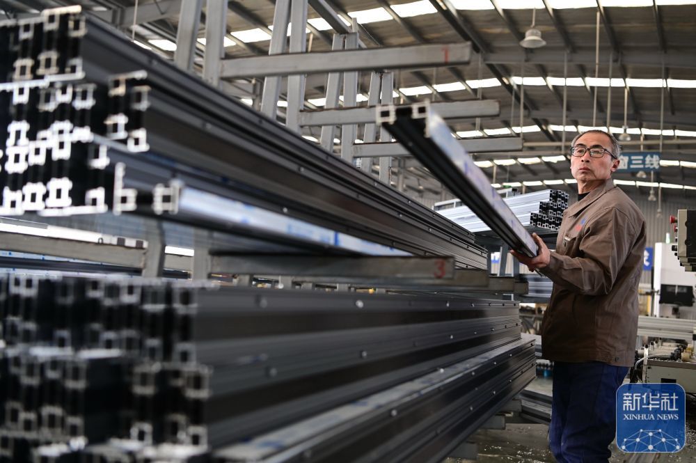 ↑ 1月5日，位于河南省沁阳市的河南兴发幕墙门窗有限公司工人在生产铝合金门窗。新华社发（杨帆摄）