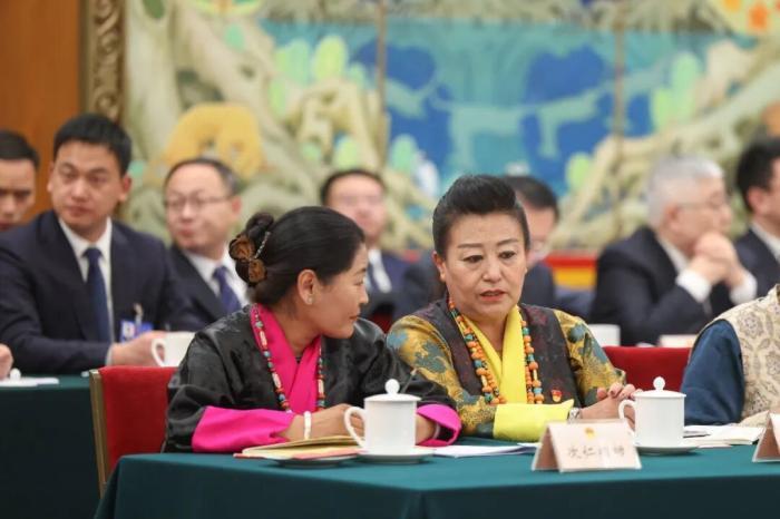 3月6日,十四届全国人大四次会议西藏代表团举行开放团组会议。图为会前,全国人大代表次仁措姆(左)和格桑卓玛交流。