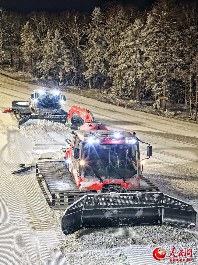 张斌驾驶压雪机在雪场内平整雪道。人民网记者李洋摄
