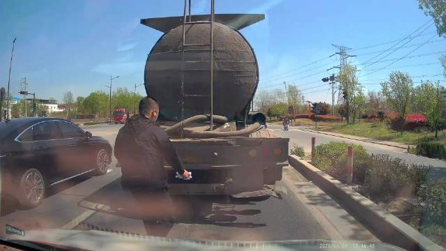 日行一善，主动帮前面大车司机把车牌擦干净