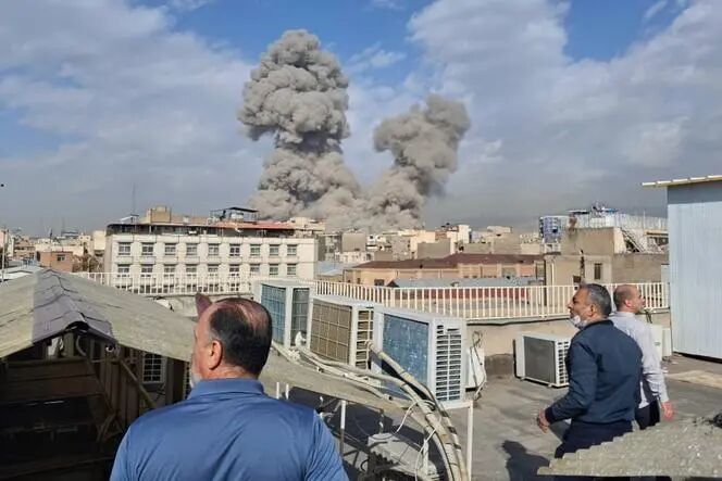 People look over the city from a rooftop after strikes in Tehran, Iran, on February 28, 2026.