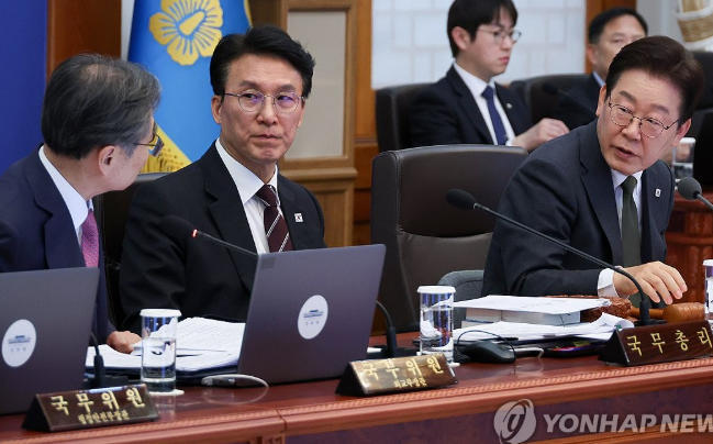 14日，赵显（左）向李在明（右）汇报中东地区情势 韩联社