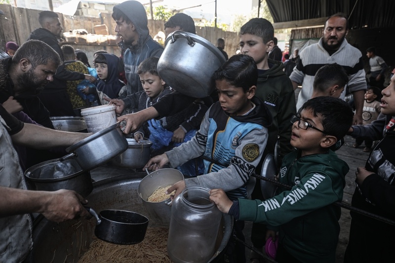 026年4月13日,在以色列持续封锁和限制援助物资进入的情况下,一家慈善机构在难民营为巴勒斯坦人分发热餐。 IC Photo