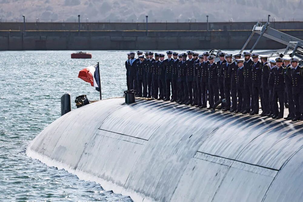 2026年3月2日,在法国西部克罗宗的长岛核潜艇基地,法国海军官兵在一艘潜艇上列队等候法国总统马克龙前来视察