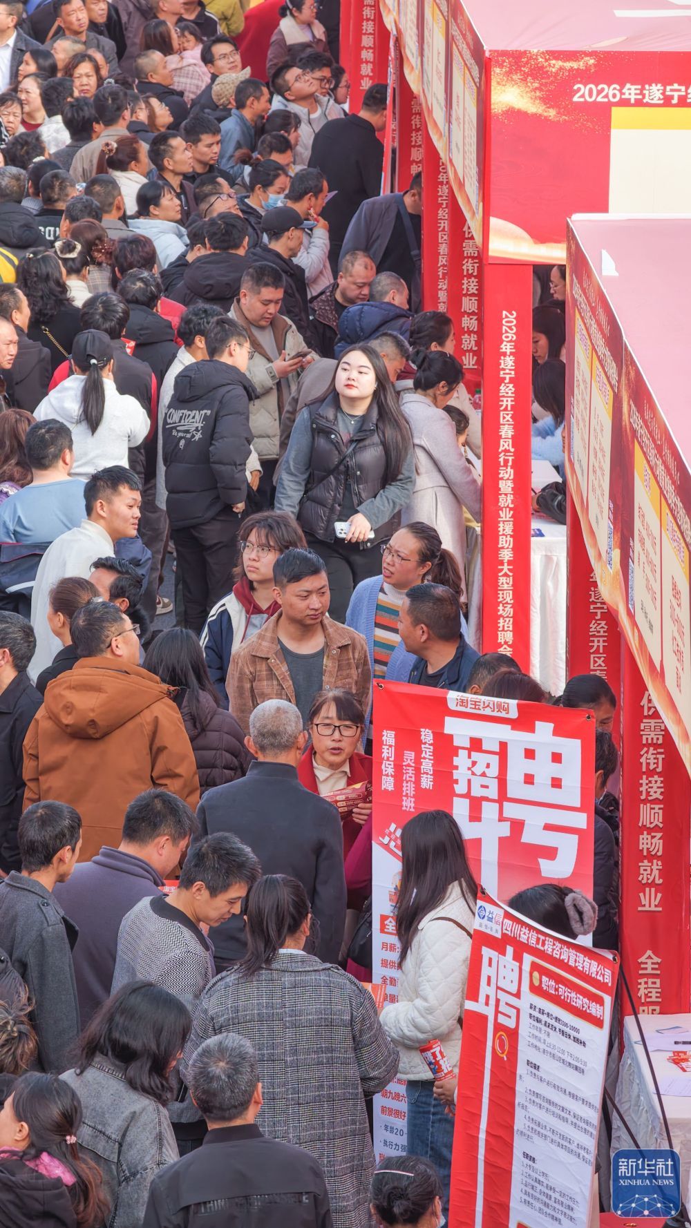 ↑ 2月24日，求职者在四川省遂宁经开区首场“春风行动”大型招聘会现场浏览岗位信息。新华社发（刘昌松 摄）