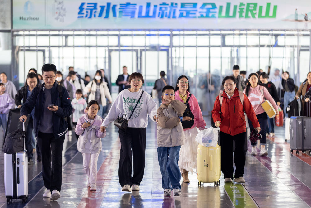 4月29日,在浙江省湖州站候车大厅,旅客检票进站。新华社发(伊凡摄)