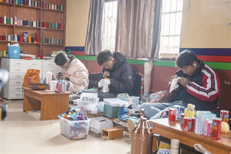学徒们正在绣制产品。