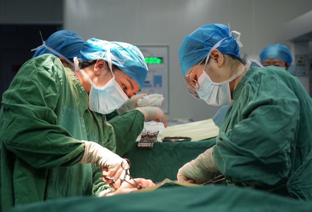 ↑ 2月16日，在广西柳州市融水苗族自治县人民医院，医护人员为患者做手术。新华社发（龙涛摄）