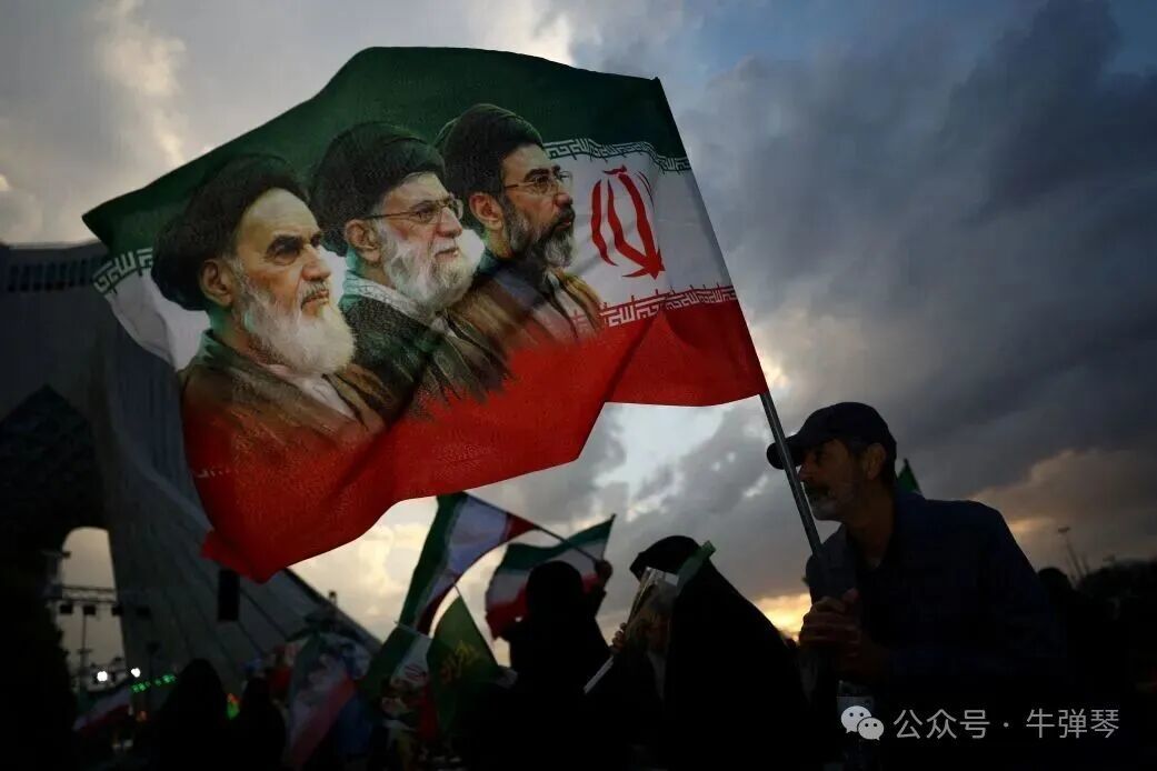 A man holds a flag picturing Ayatollah Ruhollah Khomeini, his successor Ayatollah Ali Khamenei, and his successor Mojtaba Khamenei, during a rally in Tehran on April 29.