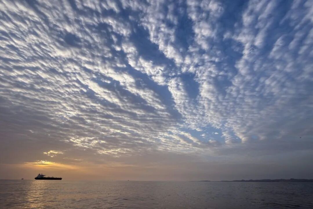 4月18日，太阳在伊朗克什姆岛海岸外的霍尔木兹海峡停泊的一艘油轮后方升起。