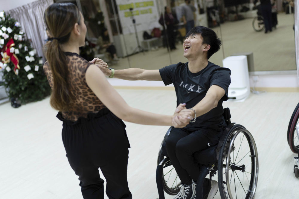 1月14日，轮椅舞蹈运动员余俊延（右）与舞伴一起练习 。新华社发（吕小炜 摄）