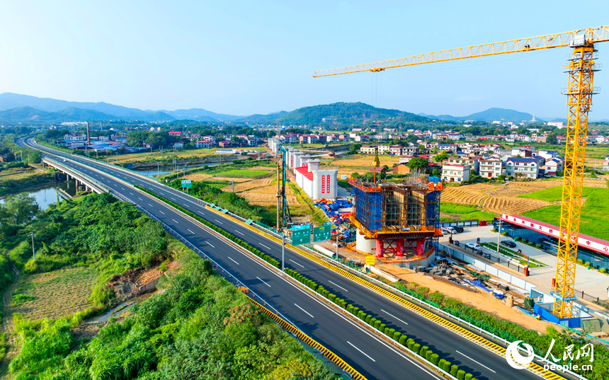 萍乡市上栗县金山镇的栗水河特大桥建设现场,塔吊林立,工业作业繁忙,基桩浇筑有序推进。人民网记者 朱海鹏摄