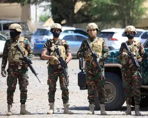 Four Houthis in military uniform carrying rifles.